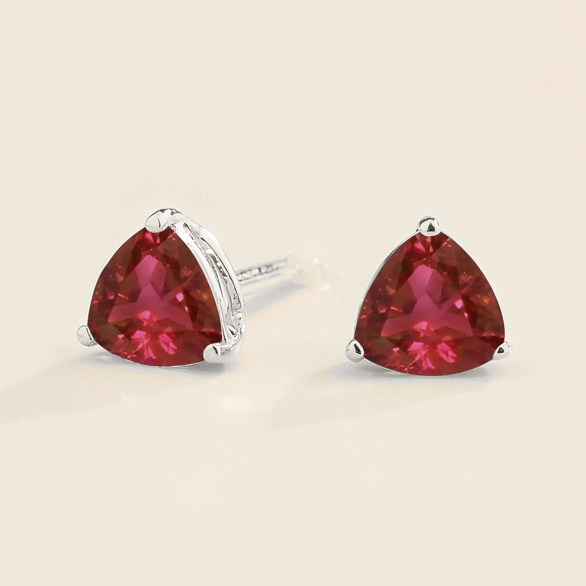 Trillion Ruby Solitaire Stud Earrings in White Gold