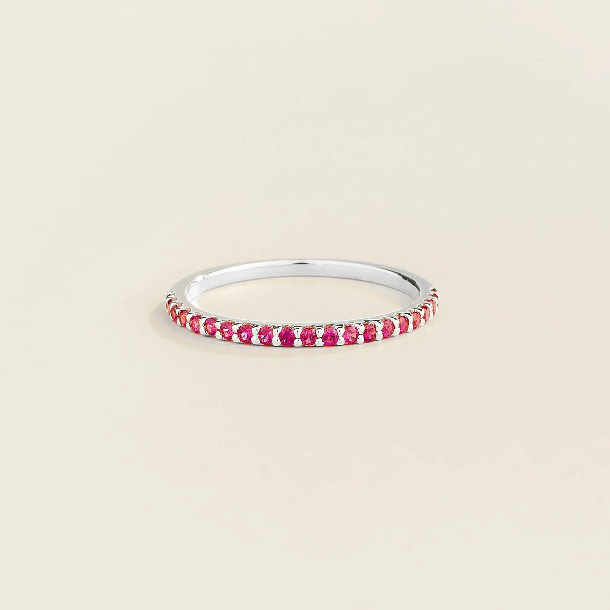 Juvetti white gold half eternity band set with round lab-grown ruby gemstones.