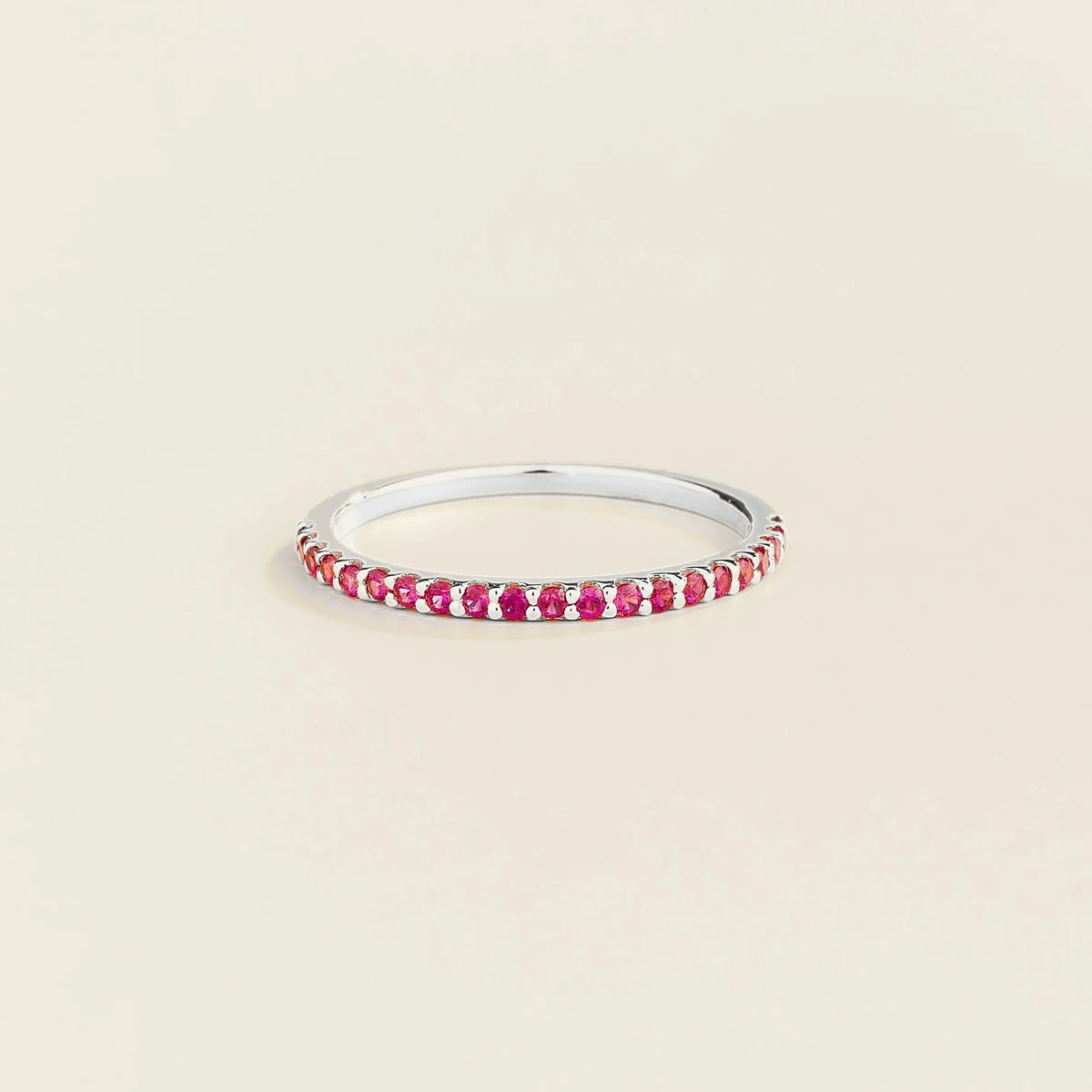 Juvetti white gold half eternity band set with round lab-grown ruby gemstones.
