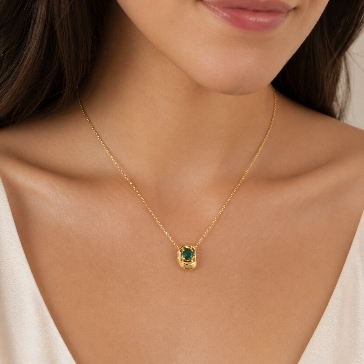 Model wears the Fava round ruby pendant necklace in white gold