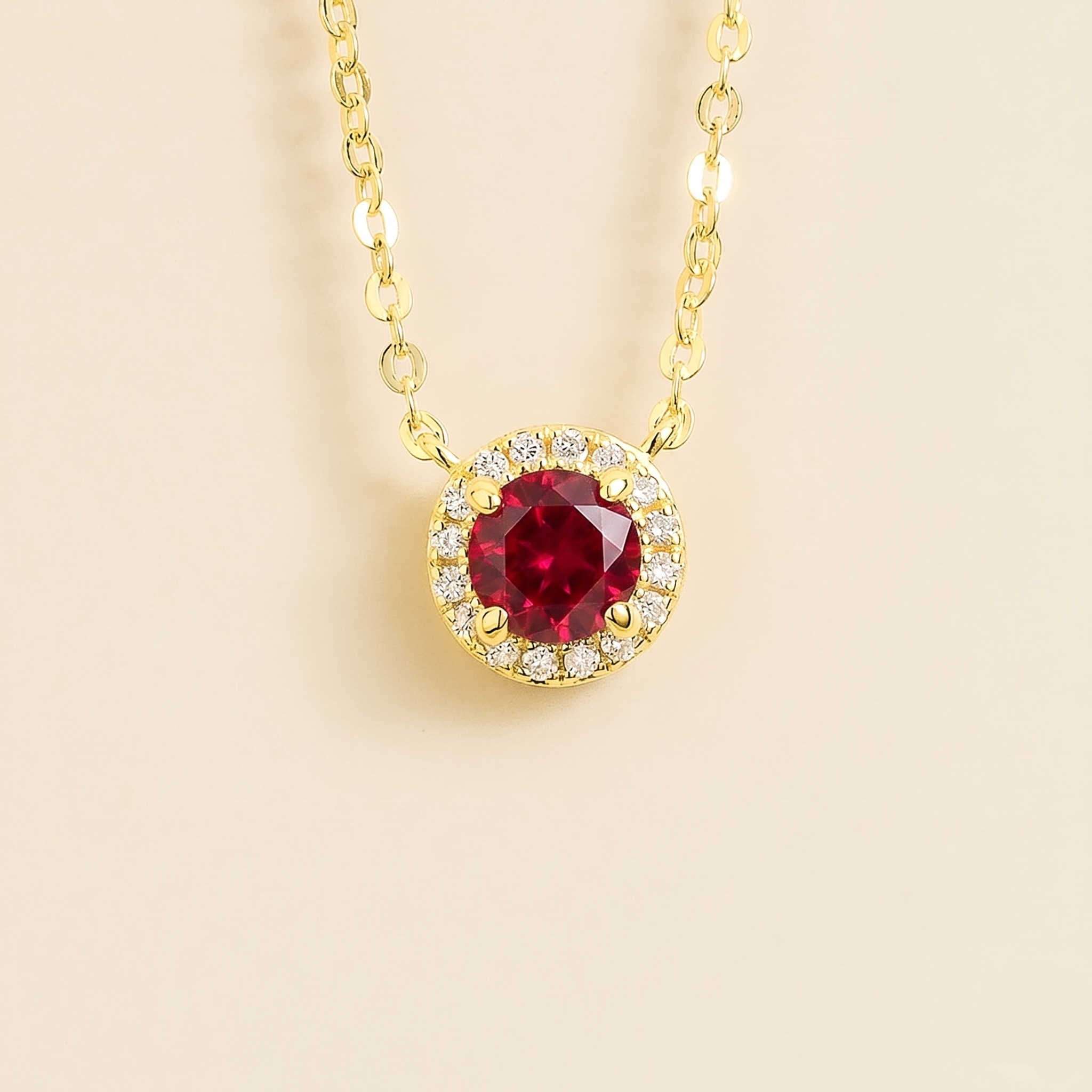 Front view of the Mars Ruby Round & Diamond Halo Necklace In Gold, handcrafted by Juvetti London