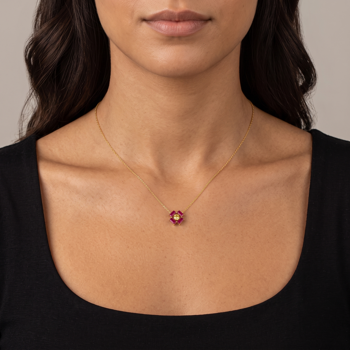 Oua ruby necklace in gold worn by a model, Juvetti London