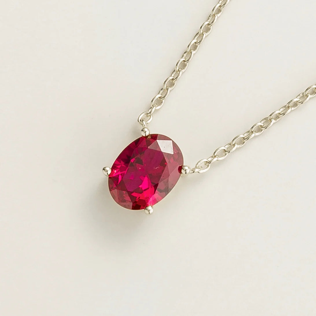 Side view of the oval ruby on the Ovo necklace in white gold, Juvetti jewellery
