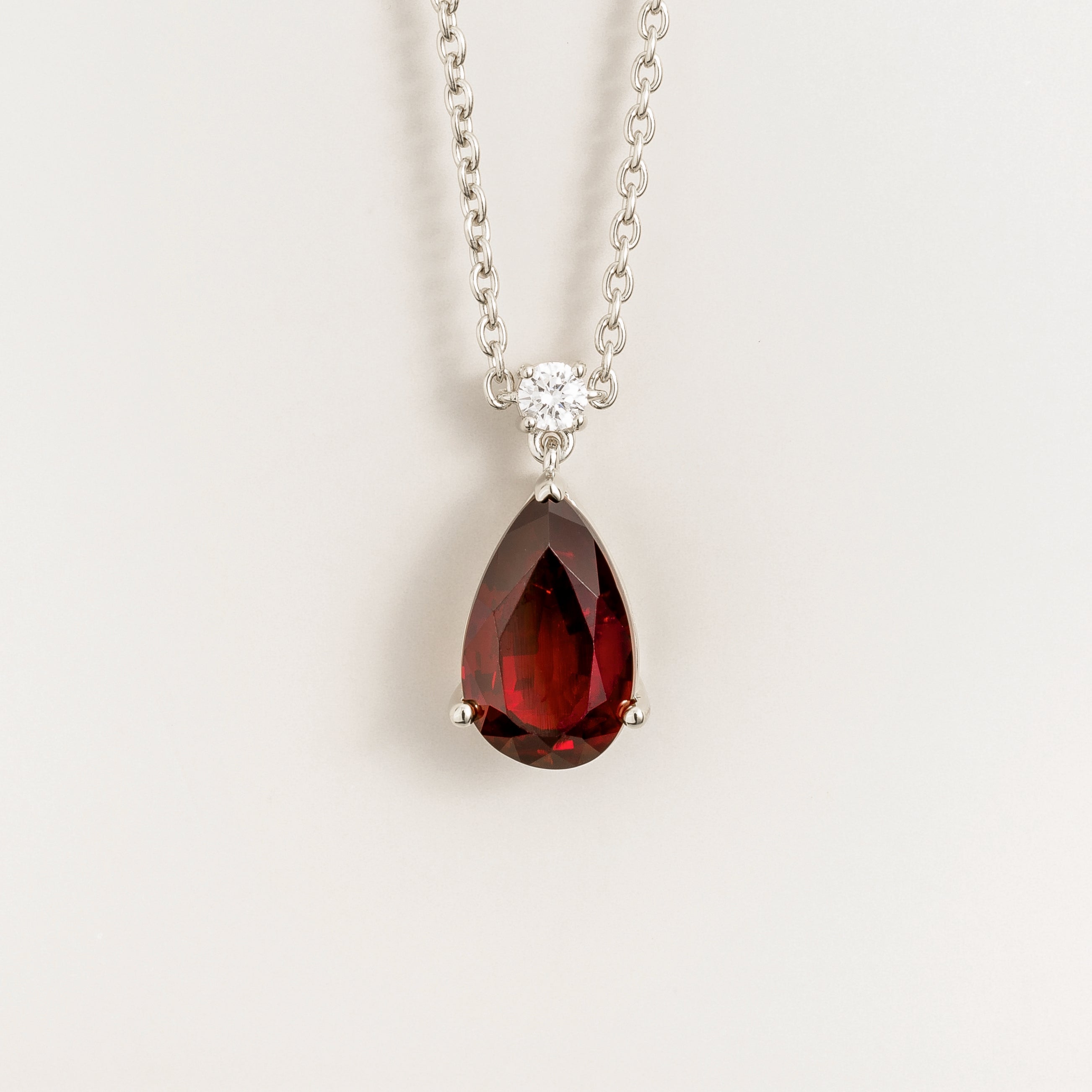 Front view of the Pisa Ruby & Diamond Pear Drop Pendant Necklace In White Gold - Large, handcrafted by Juvetti London