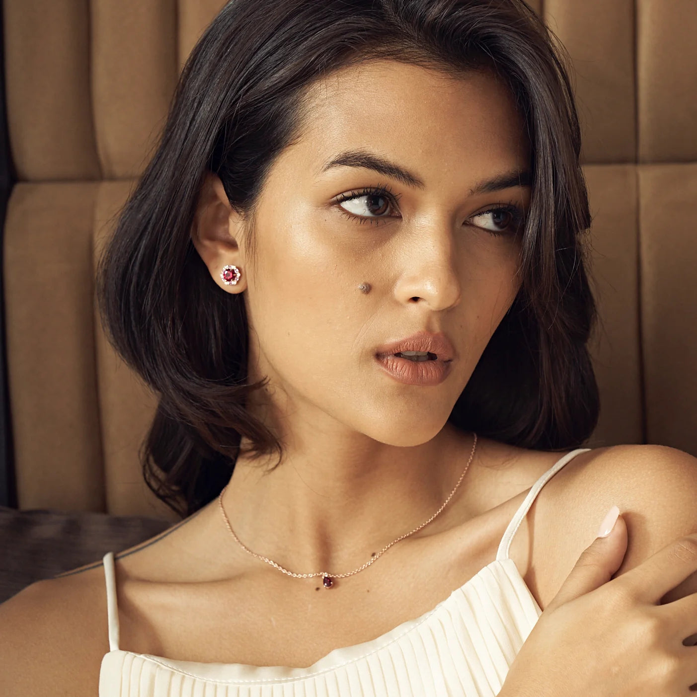 Pisa ruby necklace in rose gold worn by a model, Juvetti London