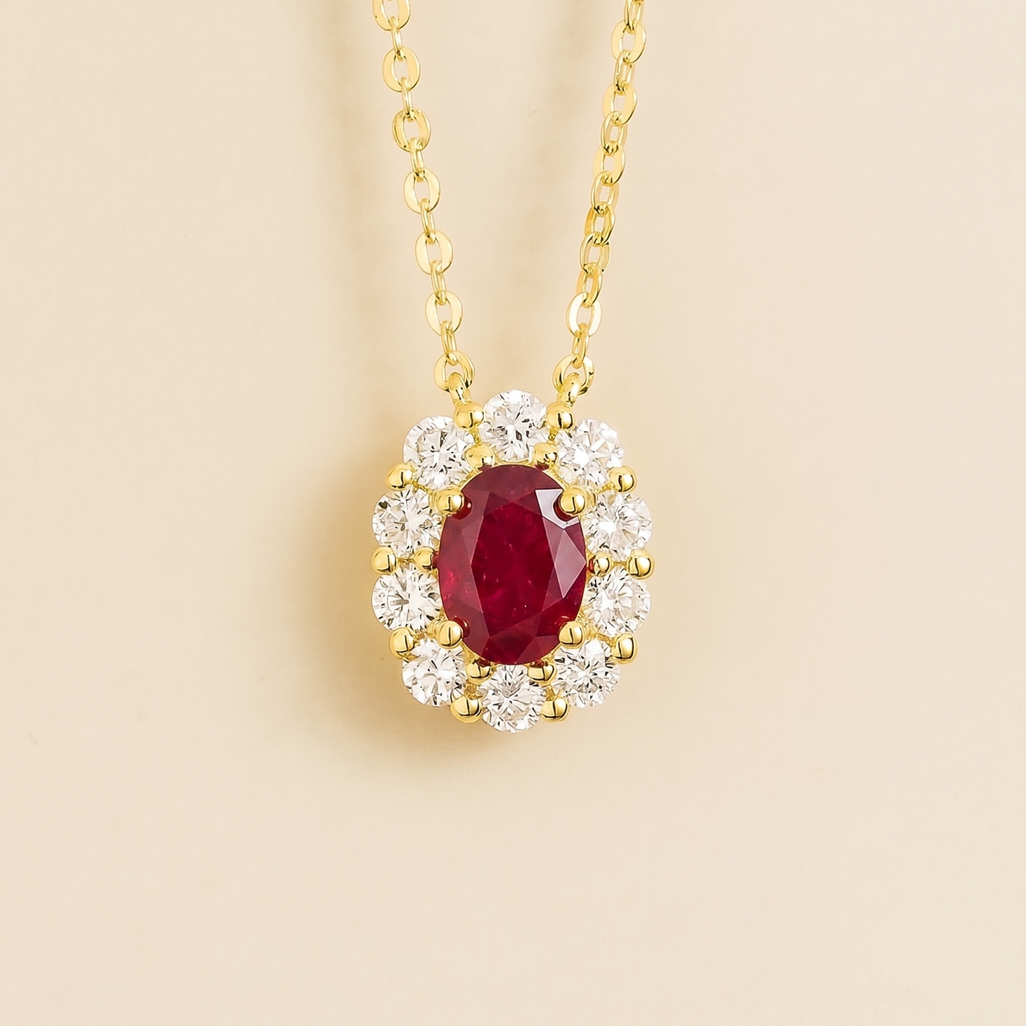 Front view of the Prill Ruby Oval & Diamond Halo Necklace In Gold, handcrafted by Juvetti London