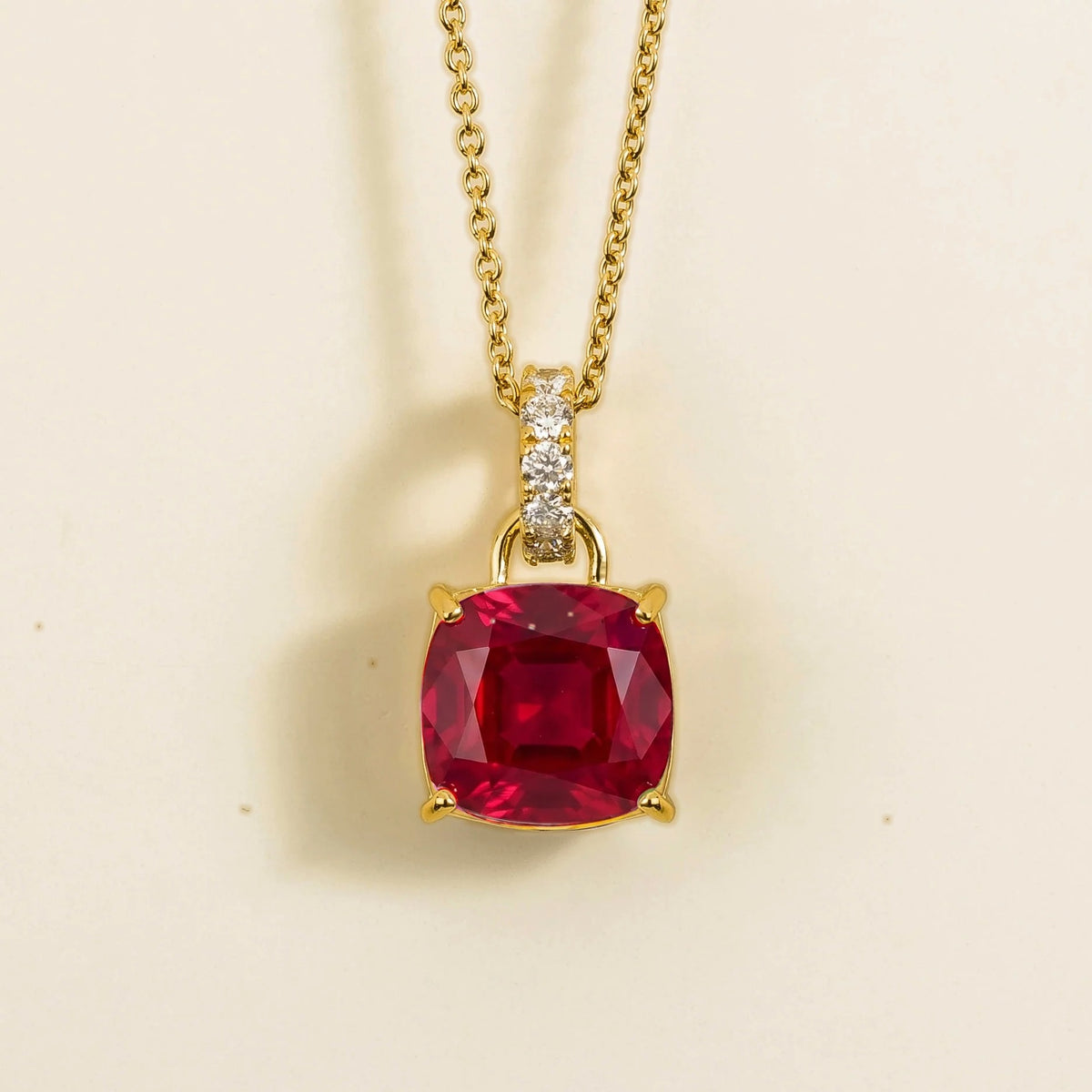Front view of the Roue Ruby Cushion Cut & Diamond Hoop Pendant Necklace in Gold, handcrafted by Juvetti London