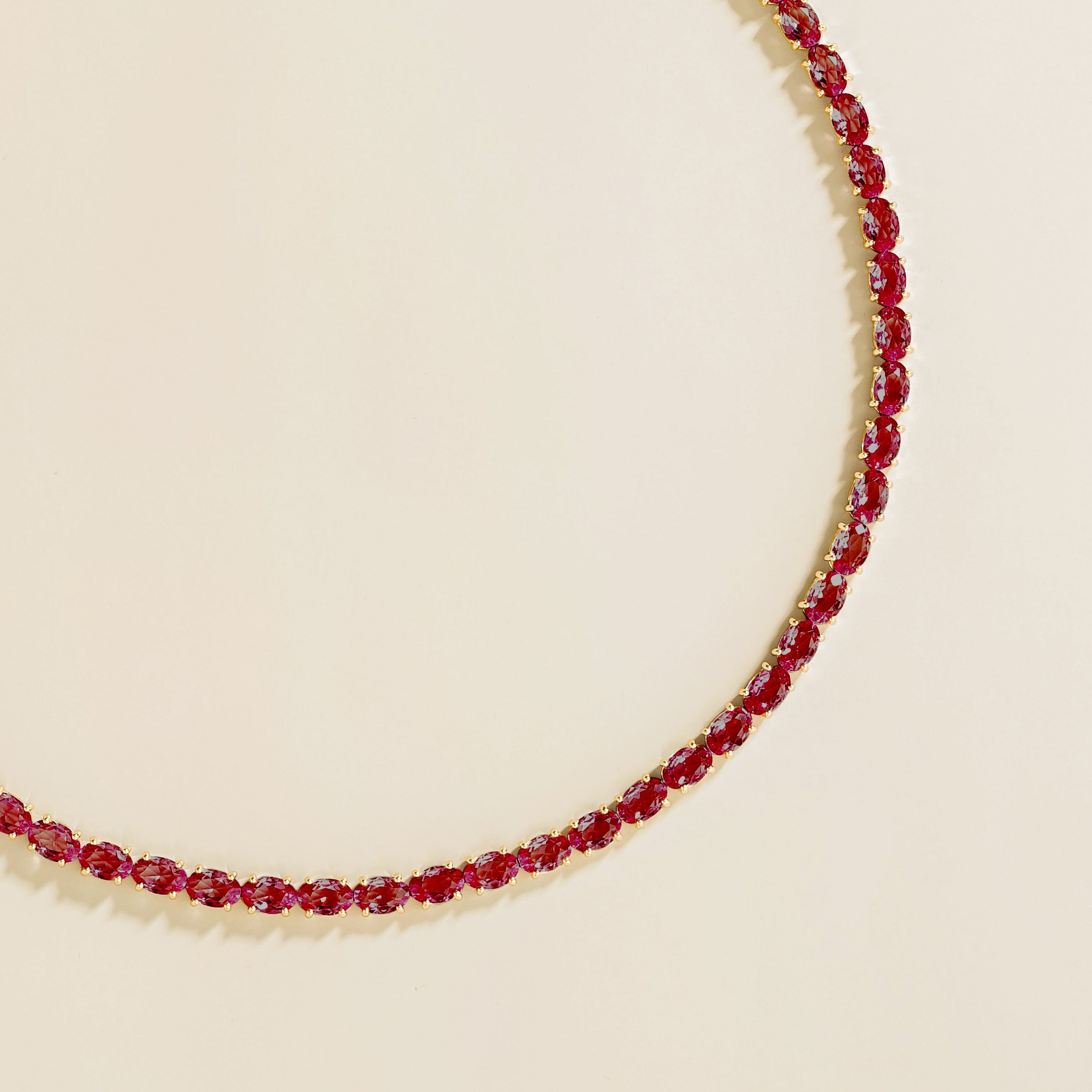 Side view of the oval ruby on the Salto necklace in gold, Juvetti jewellery