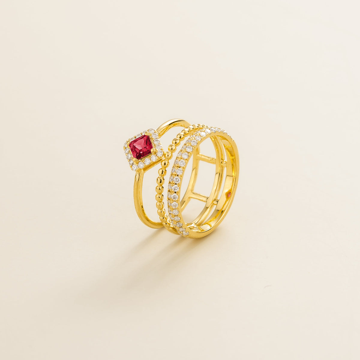 Amici triple-band stacking ring in gold, princess-cut lab-grown ruby in a diamond halo with beaded and pavé bands, side view | Juvetti London