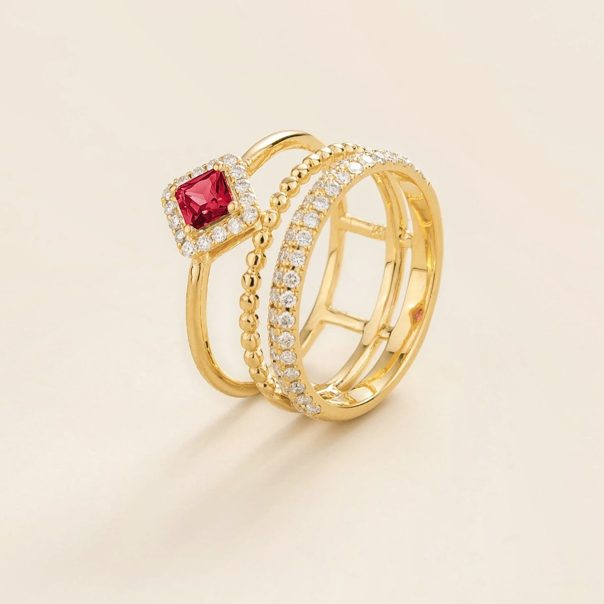 Amici triple-band stacking ring in gold, princess-cut lab-grown ruby in a diamond halo with beaded and pavé bands, side view | Juvetti London