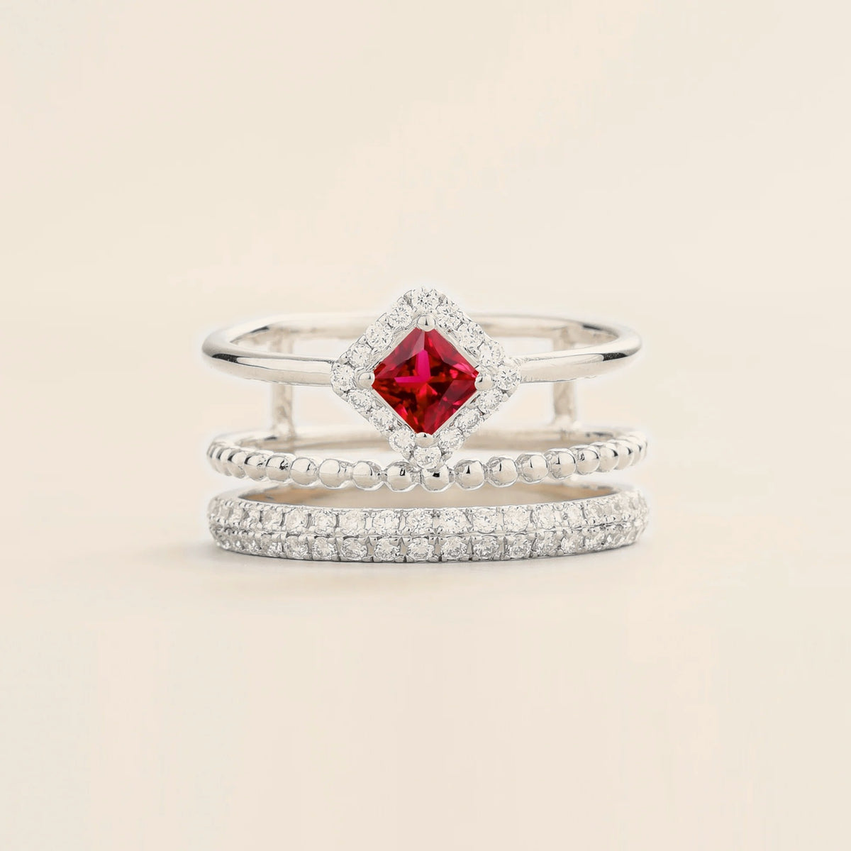 Amici triple-band stacking ring in white gold, princess-cut lab-grown ruby in a diamond halo with beaded and pavé bands, front view | Juvetti London