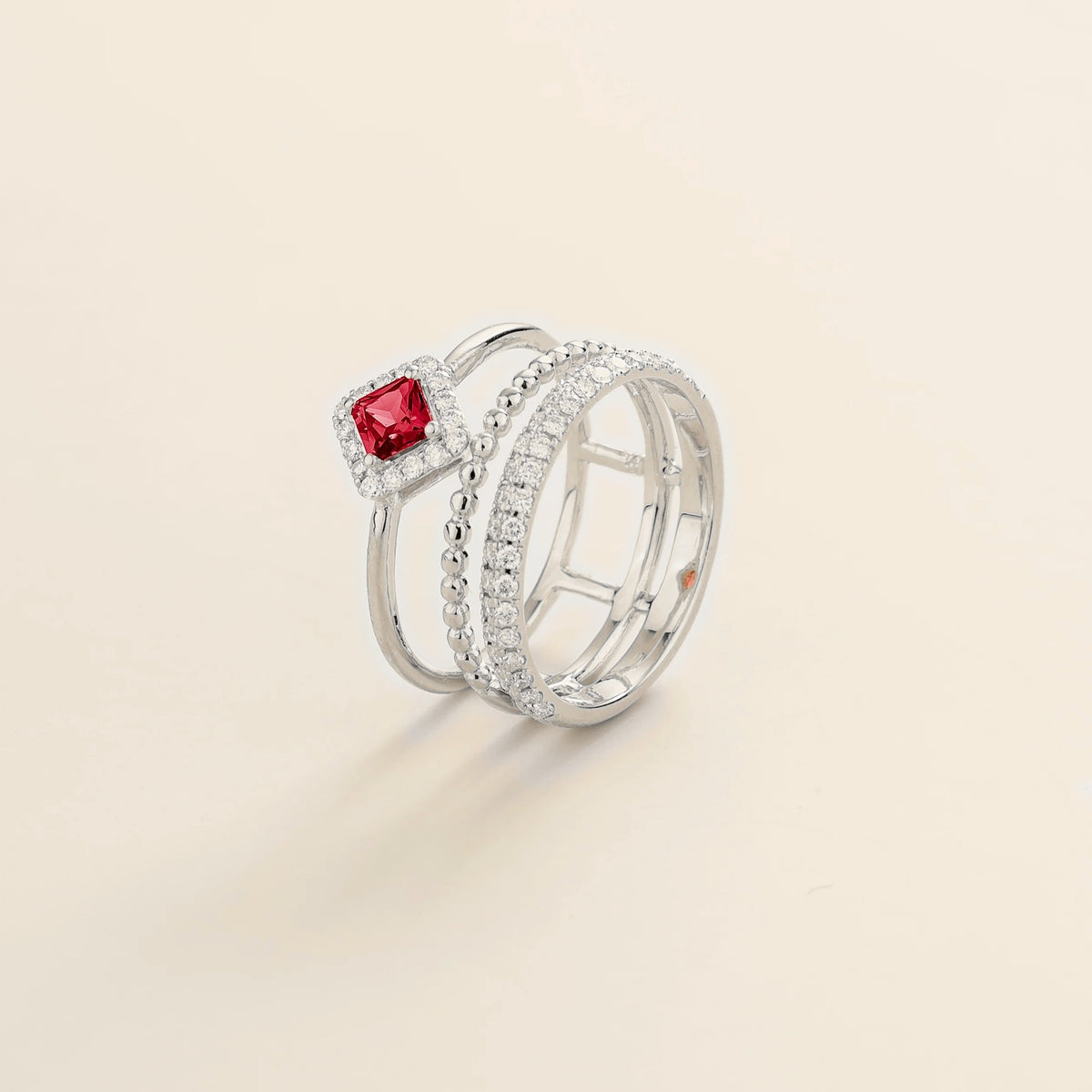 Amici triple-band stacking ring in white gold, princess-cut lab-grown ruby in a diamond halo with beaded and pavé bands, side view | Juvetti London