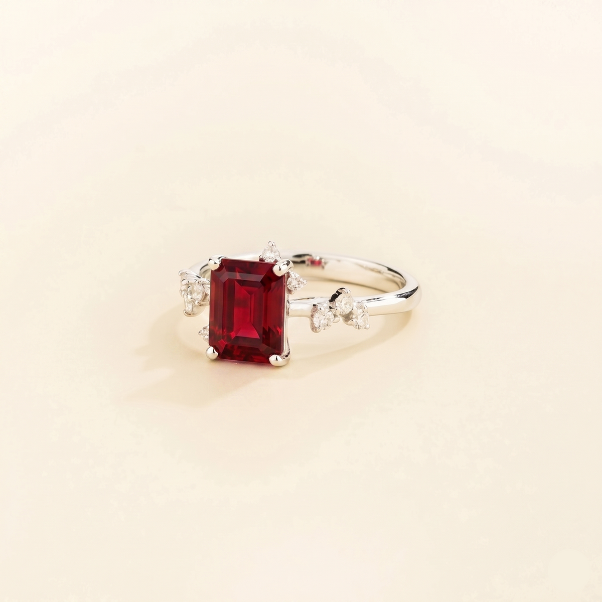 Frost emerald-cut ruby and diamond ring in white gold, lab-grown ruby with scattered diamonds, side view | Juvetti London