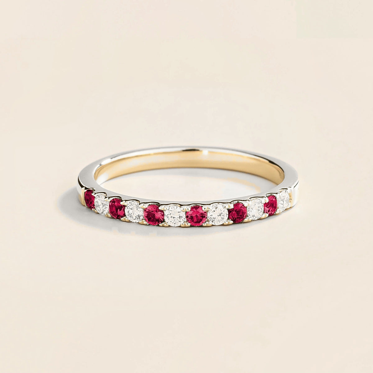 Salto white gold half eternity ring featuring alternating rubies and diamonds along its circumference.