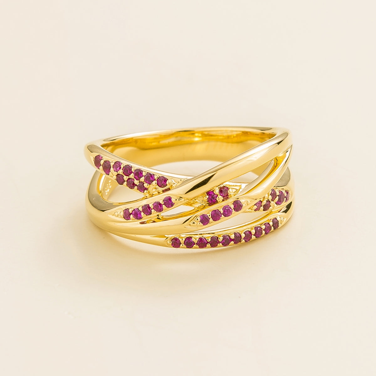 Val multi-row crossover band ring with lab-grown rubies in gold – front view | Juvetti London
