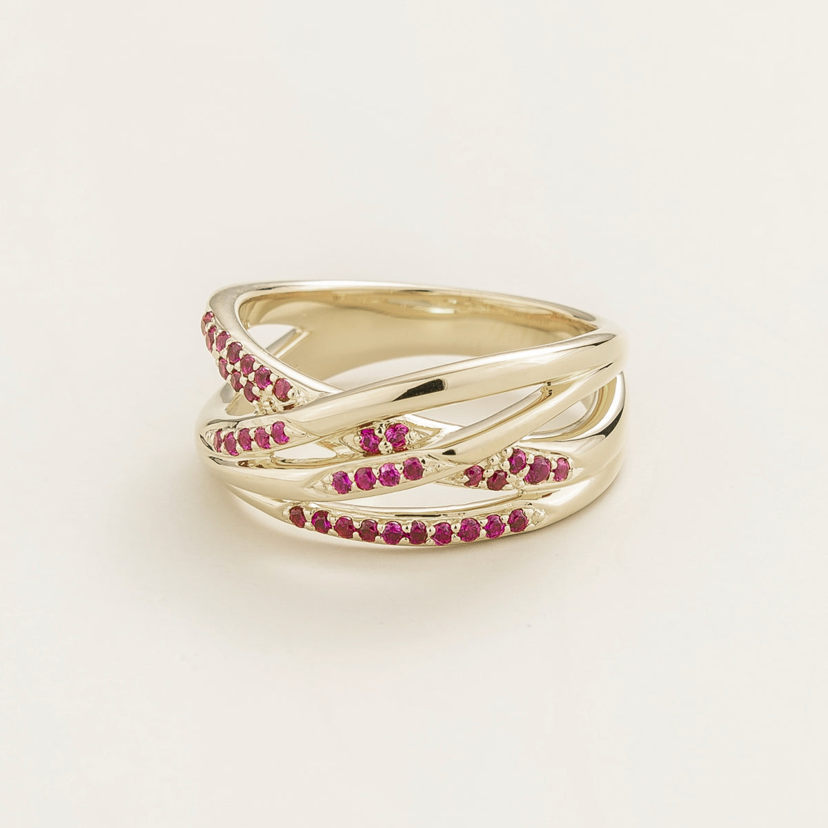 Val multi-row crossover band ring with lab-grown rubies in white gold – angle view | Juvetti London