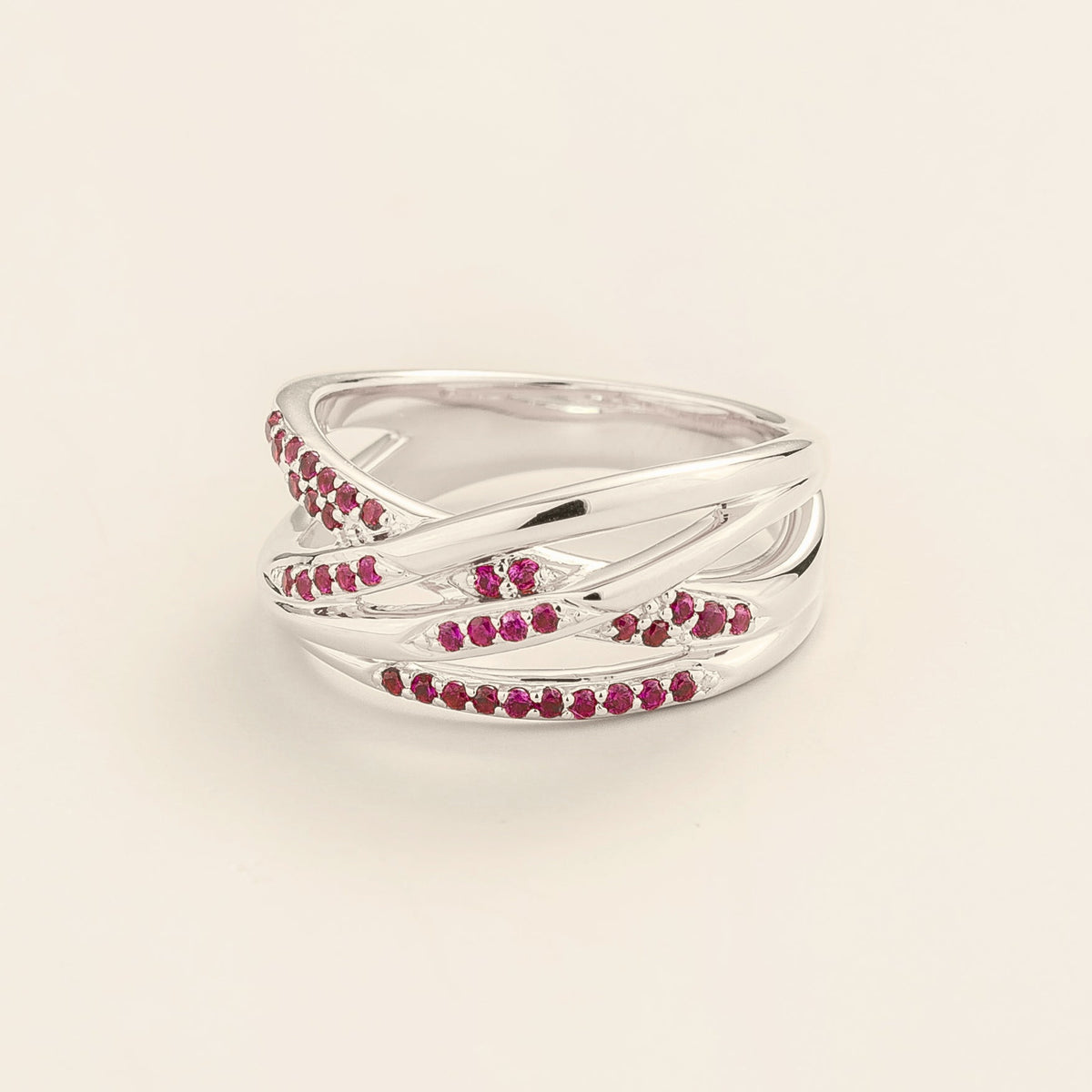 Val multi-row crossover band ring with lab-grown rubies in white gold – angle view | Juvetti London