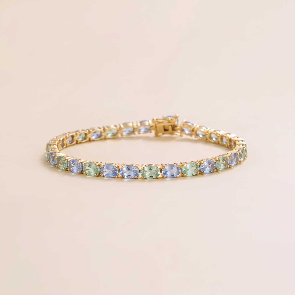 Oval lab-grown pastel blue and green sapphire tennis bracelet in gold | Juvetti London.