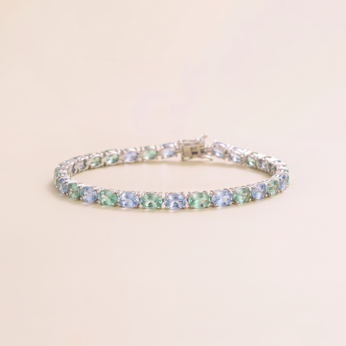 Oval lab-grown pastel blue and green sapphire tennis bracelet in white gold | Juvetti London.