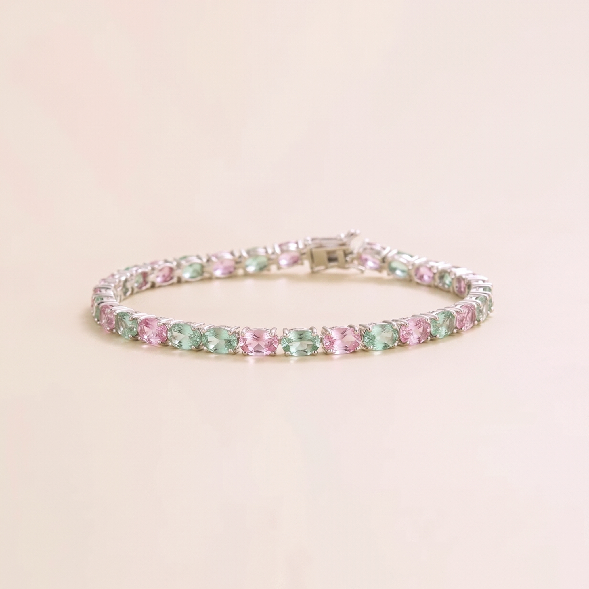 Oval lab-grown pastel pink and green sapphire tennis bracelet in white gold | Juvetti London.
