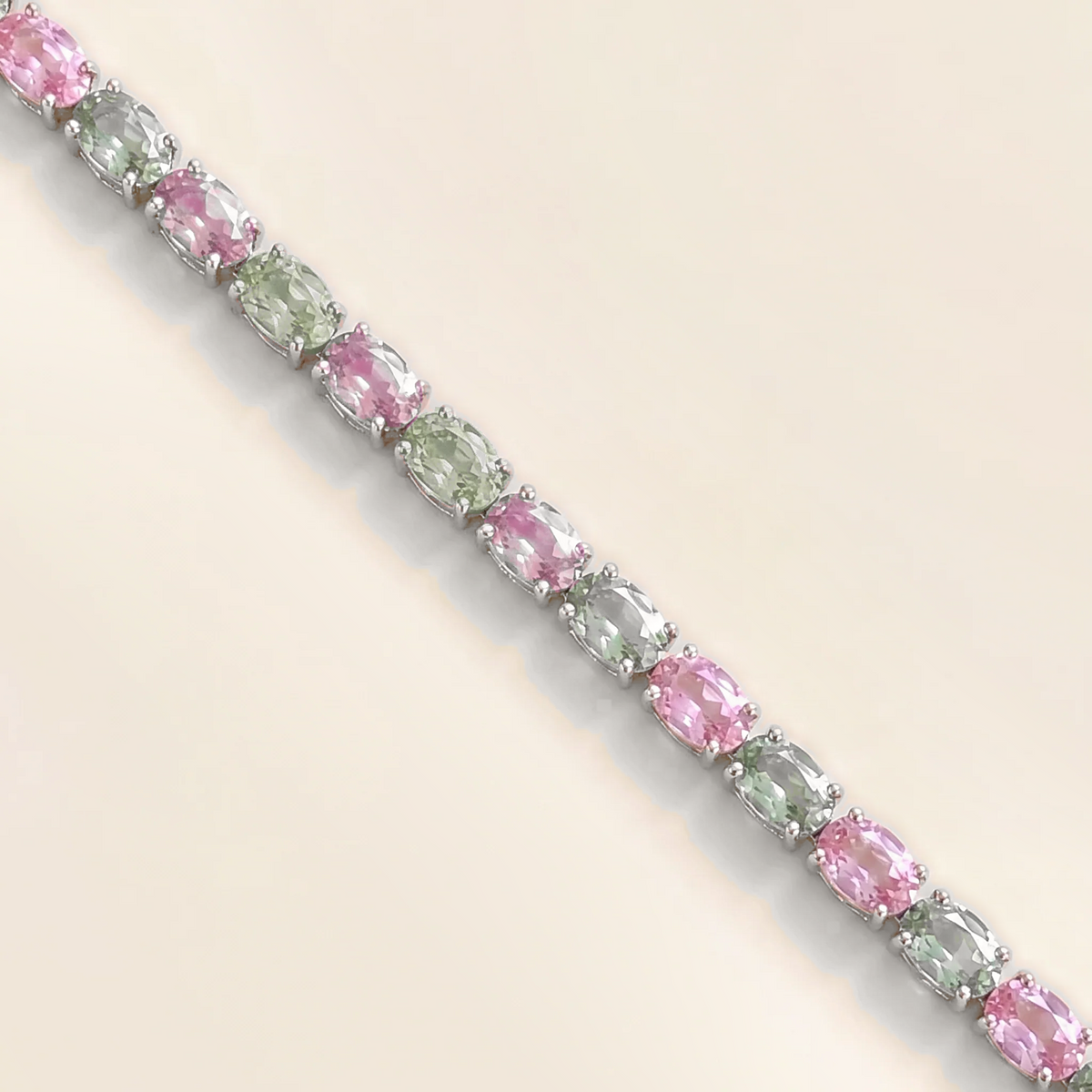 Salto pastel pink and green sapphire oval tennis bracelet in white gold