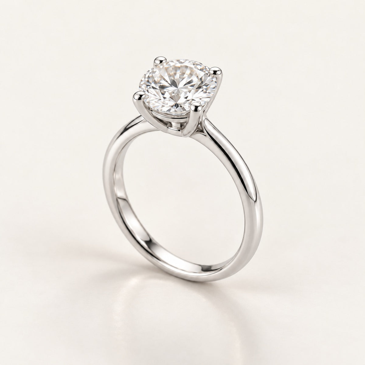 Solitaire ring setting in white gold or platinum, shown with a 1 ct round diamond