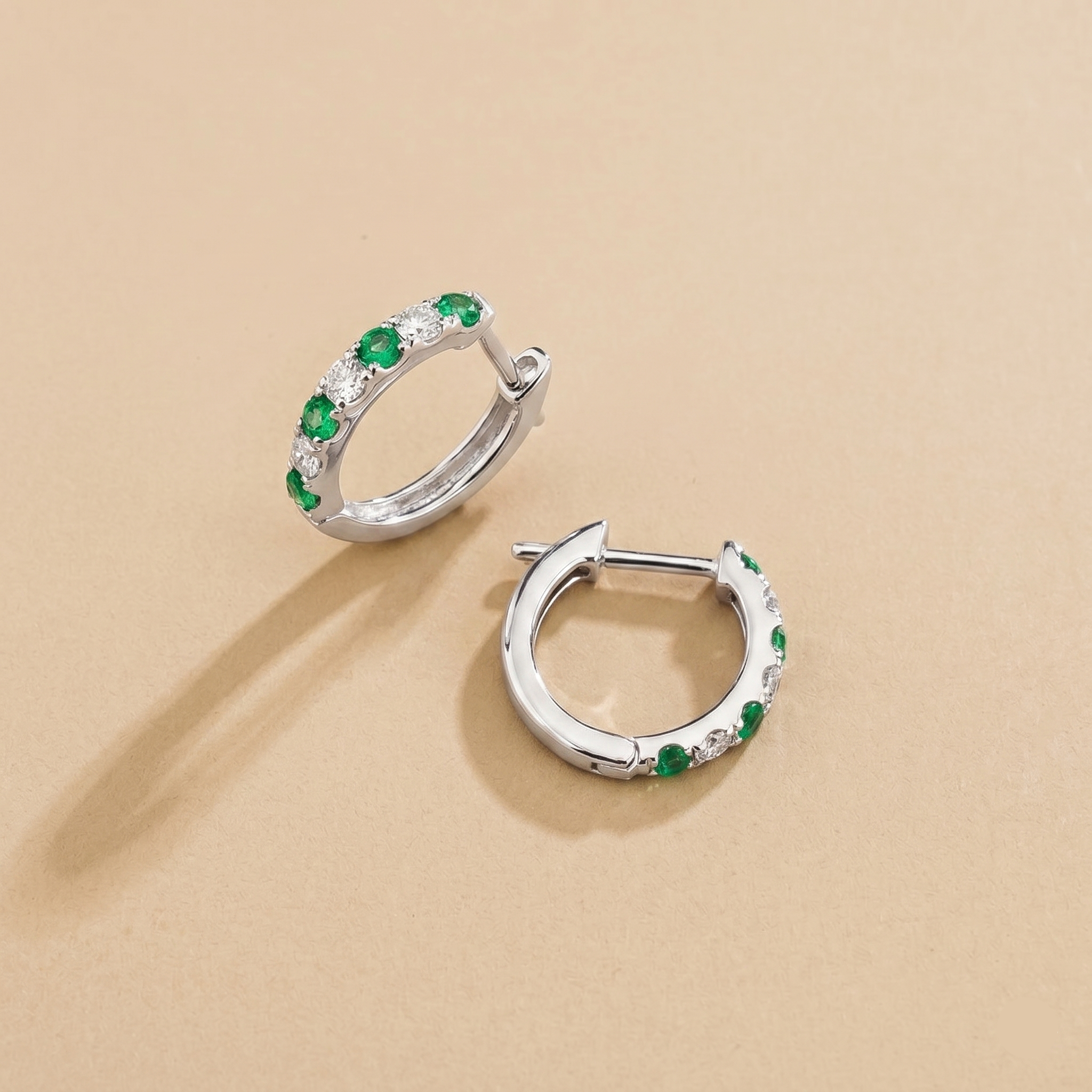 Stacy Emerald & Diamond Huggie Hoop Earrings in White Gold – angle view