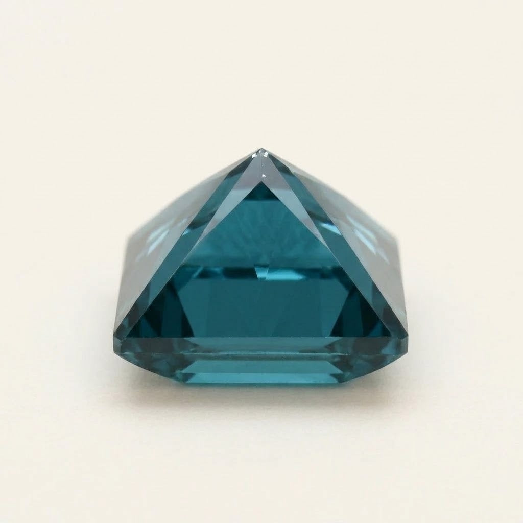Teal lab-grown sapphire, princess cut, side view
