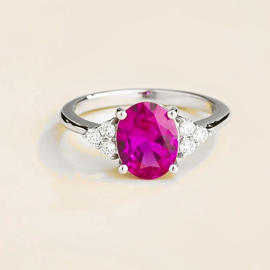Ovo vivid pink sapphire oval solitaire ring with diamond shoulders in white gold