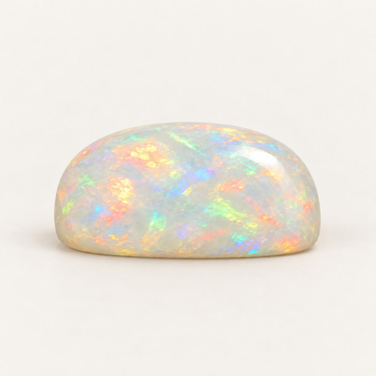White lab-grown opal, cushion cabochon, side view