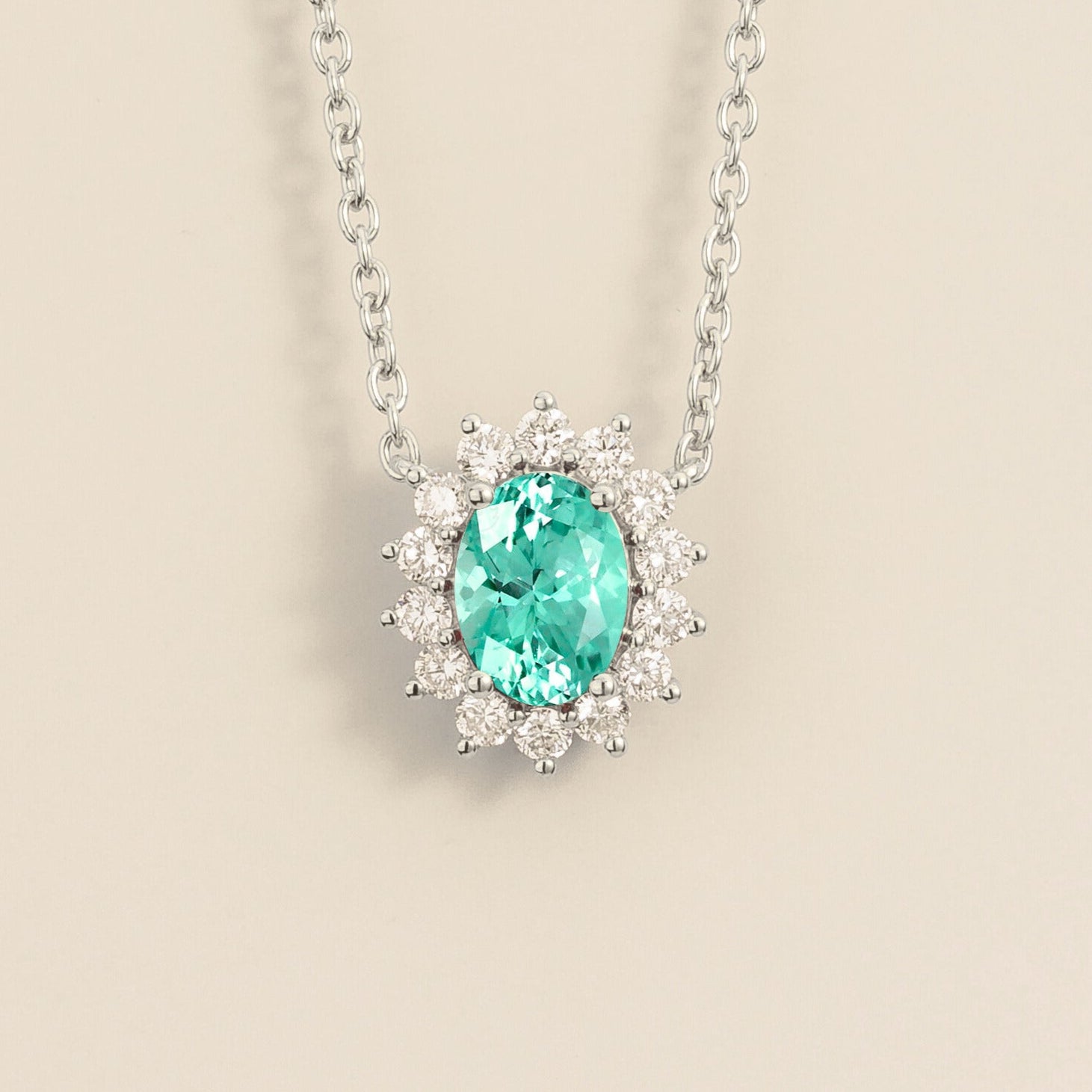 A white gold necklace from juvetti set with paraiba sapphire and diamonds.