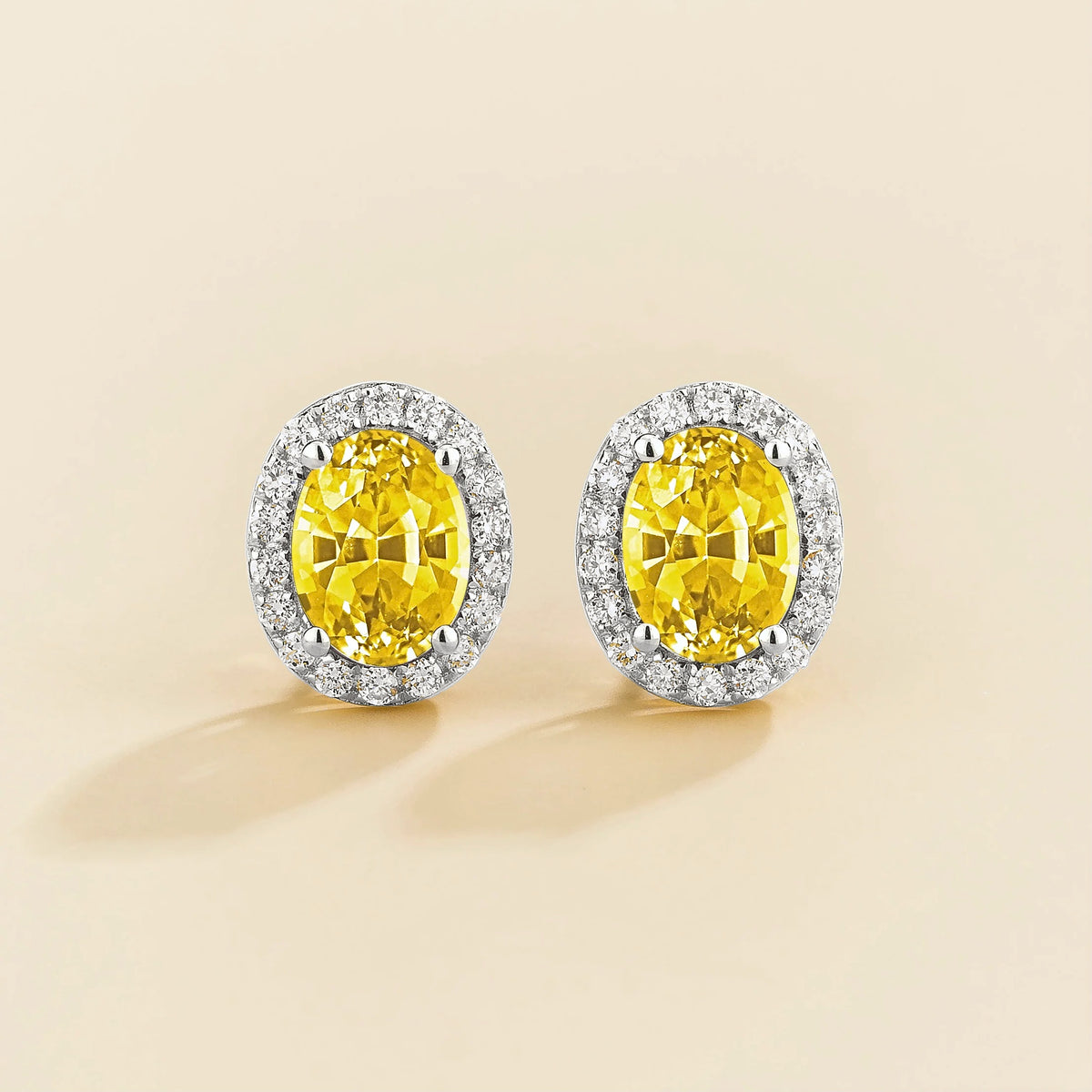 Lab-grown yellow sapphire and diamond oval halo stud earrings in white gold – front view | Mina by Juvetti