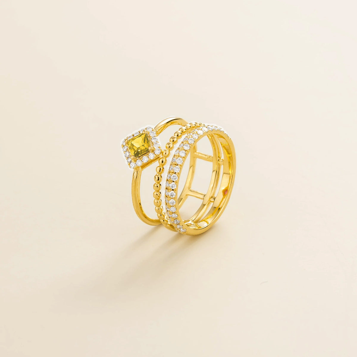 Amici triple-band stacking ring in gold, princess-cut lab-grown yellow sapphire in a diamond halo with beaded and pavé bands, side view | Juvetti London