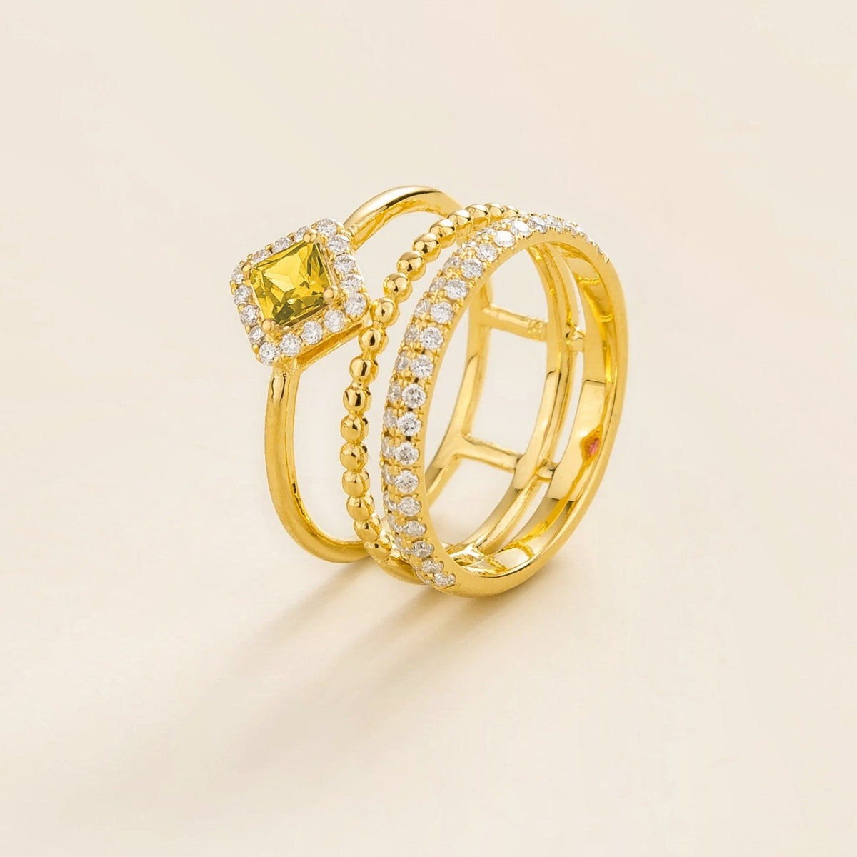 Amici triple-band stacking ring in gold, princess-cut lab-grown yellow sapphire in a diamond halo with beaded and pavé bands, side view | Juvetti London