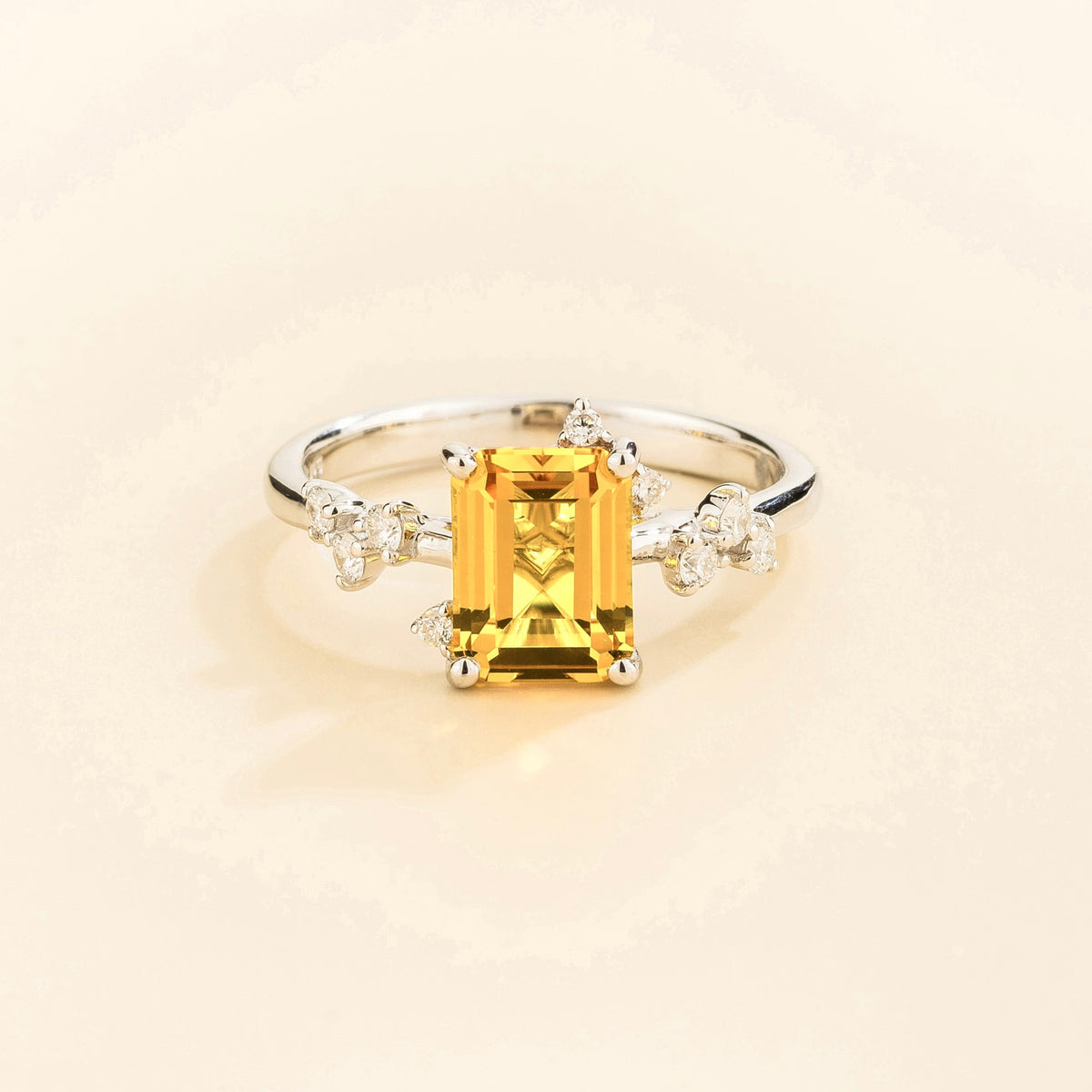 Frost emerald-cut yellow sapphire and diamond ring in white gold, lab-grown sapphire with scattered diamonds, front view | Juvetti London