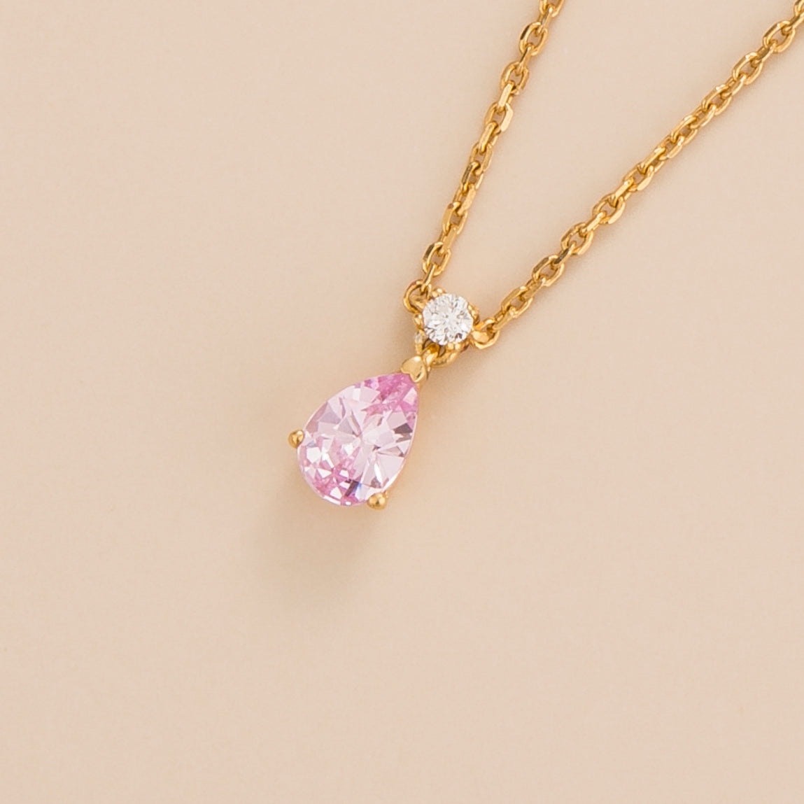 Lab-grown pastel pink sapphire and diamond pear drop pendant necklace in gold, small – angled view | Pisa by Juvetti