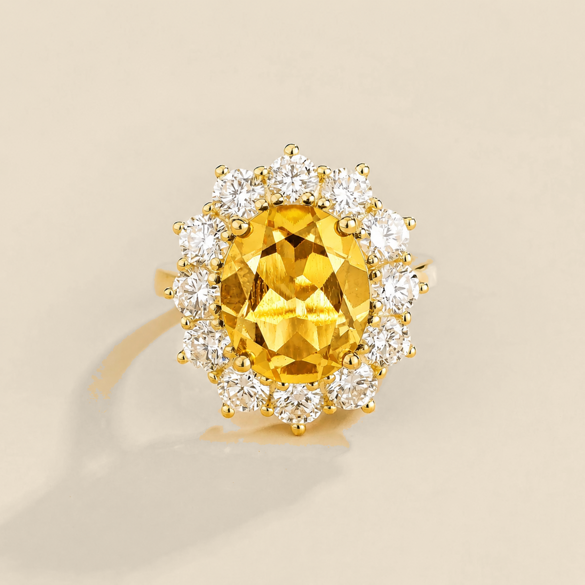 Juvetti yellow gold halo ring featuring an oval lab-grown yellow sapphire surrounded by round lab-grown diamonds.