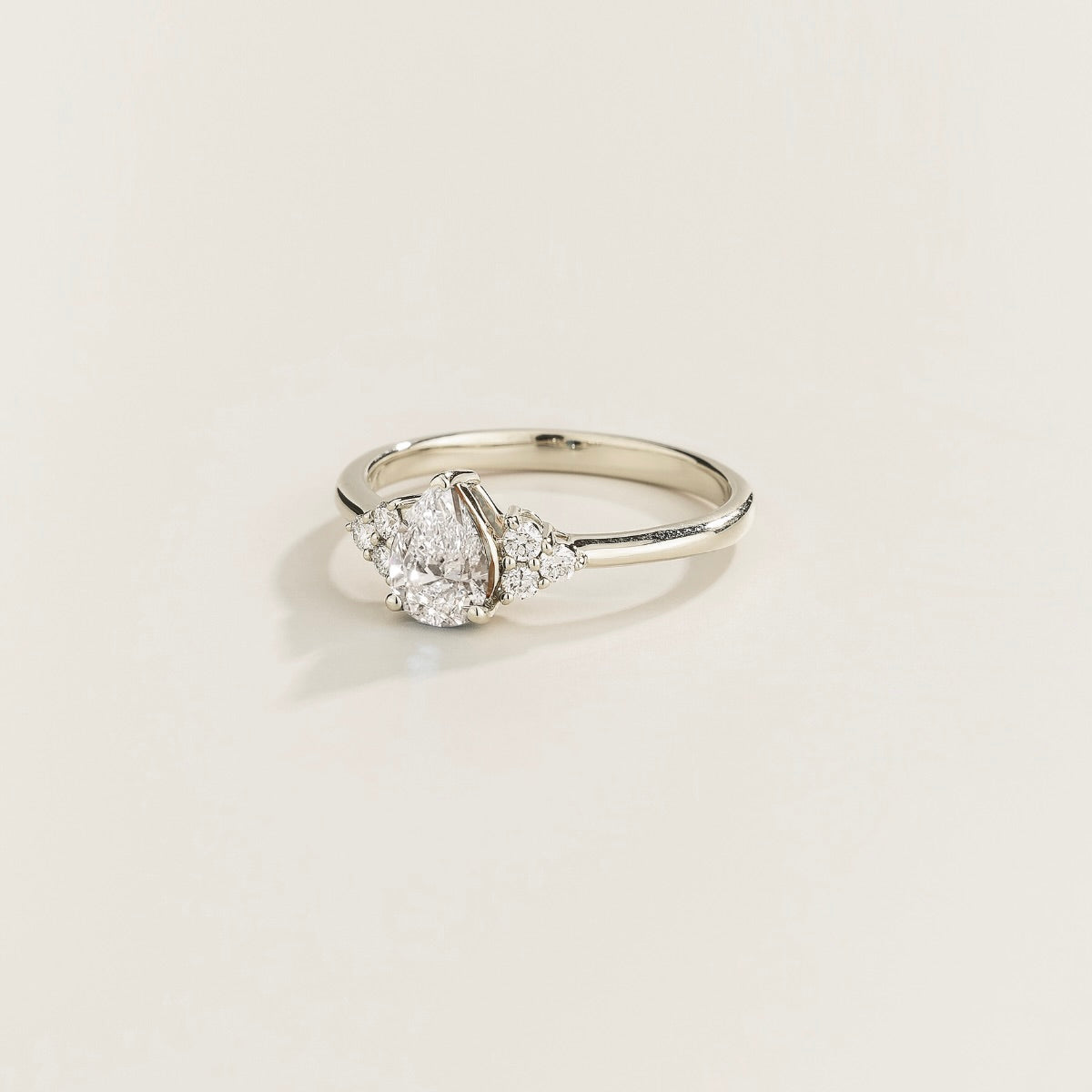 Juvetti white gold ring featuring a pear-cut lab-grown diamond with lab-grown diamond side stones.