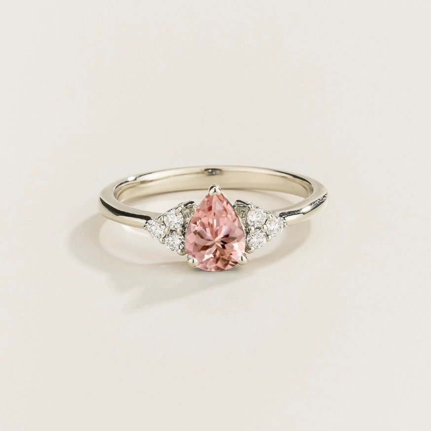 Juvetti white gold ring featuring a pear-cut lab-grown morganite with lab-grown diamond side stones.
