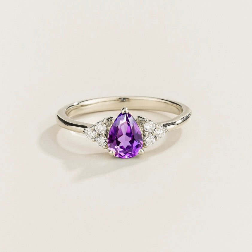 Juvetti white gold ring featuring a pear-cut lab-grown purple sapphire with lab-grown diamond side stones.