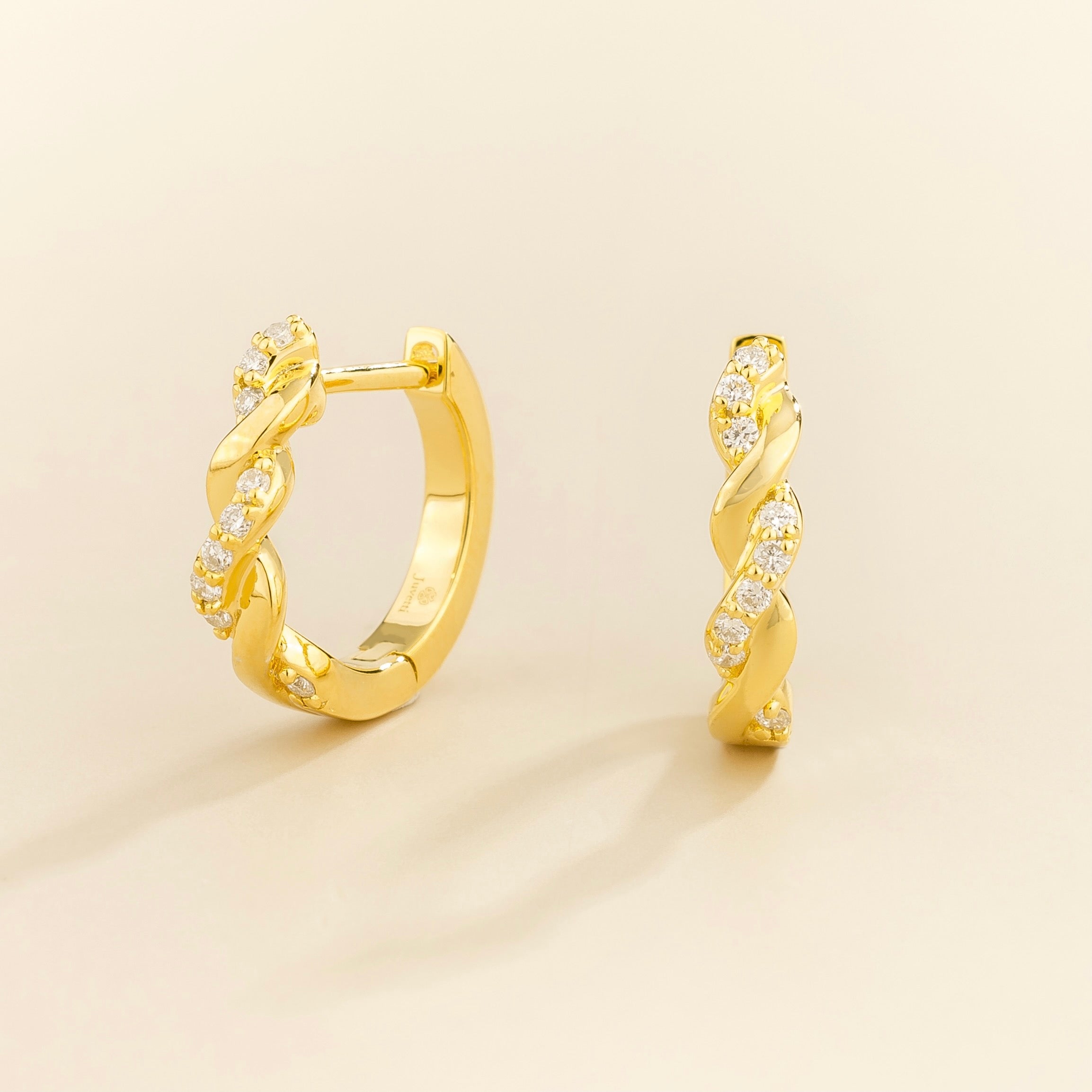 Juvetti yellow gold twisted hoop earrings with lab-grown diamonds.