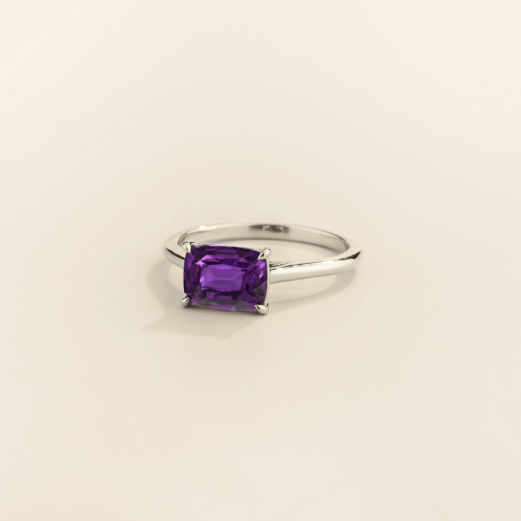 Kissen Ring in white gold, set with a Purple Sapphire in an east–west setting.