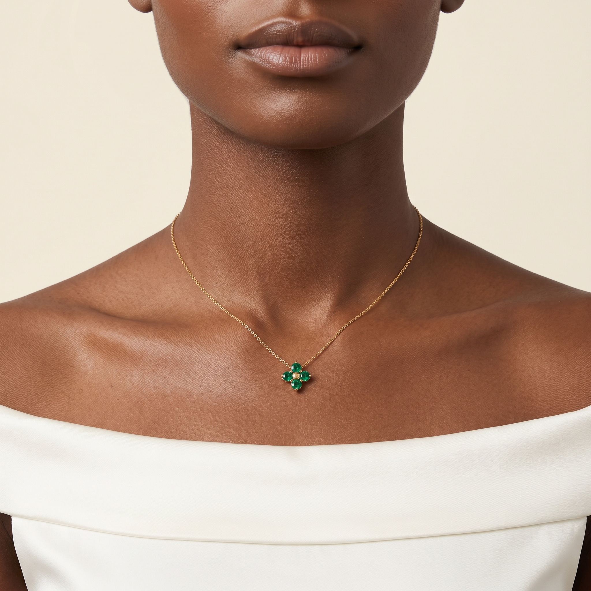 A model is wearing Clover Emerald Necklace in Gold set with Round cut Emerald Gemstones.