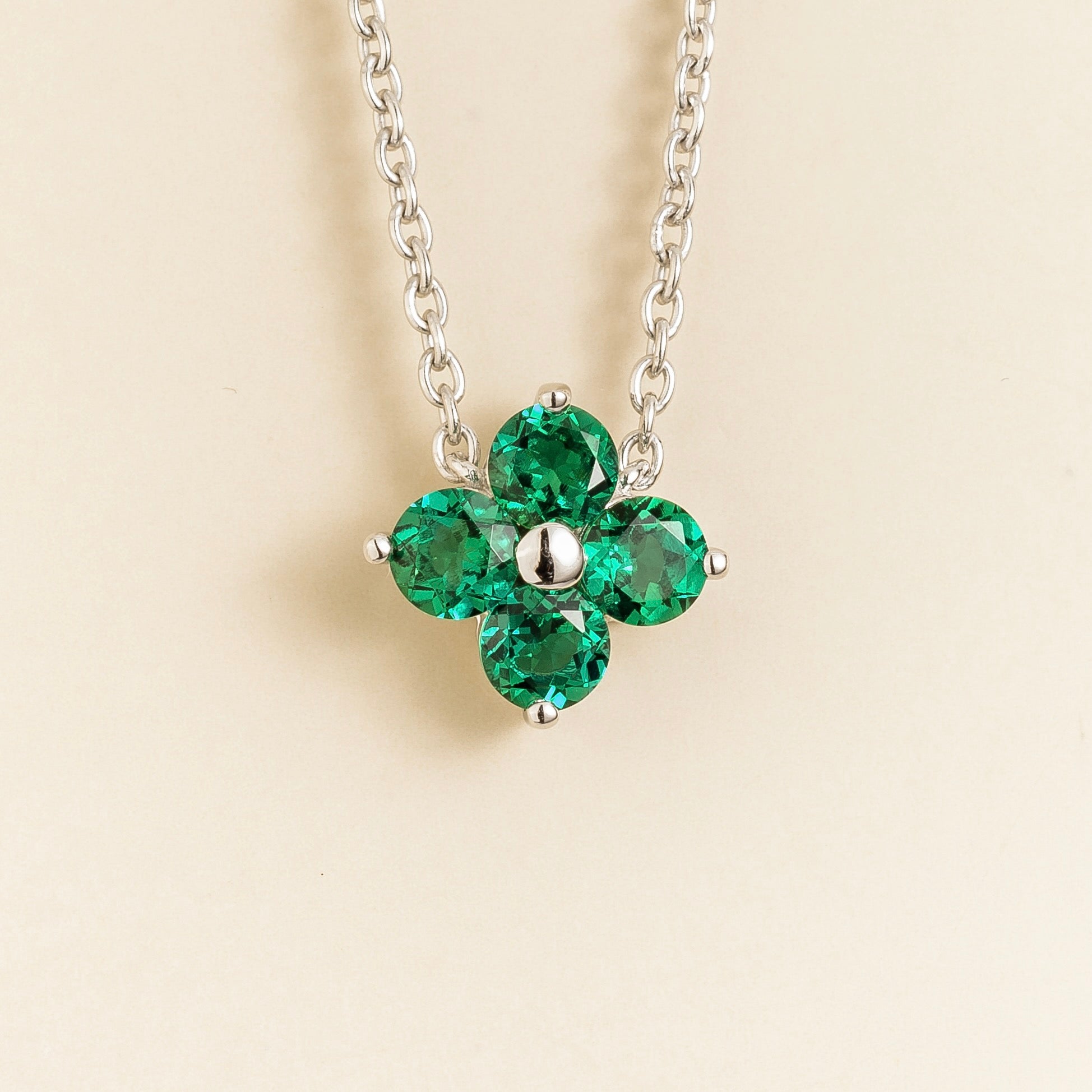 Juvetti white gold necklace featuring a clover pendant set with round lab-grown emeralds.