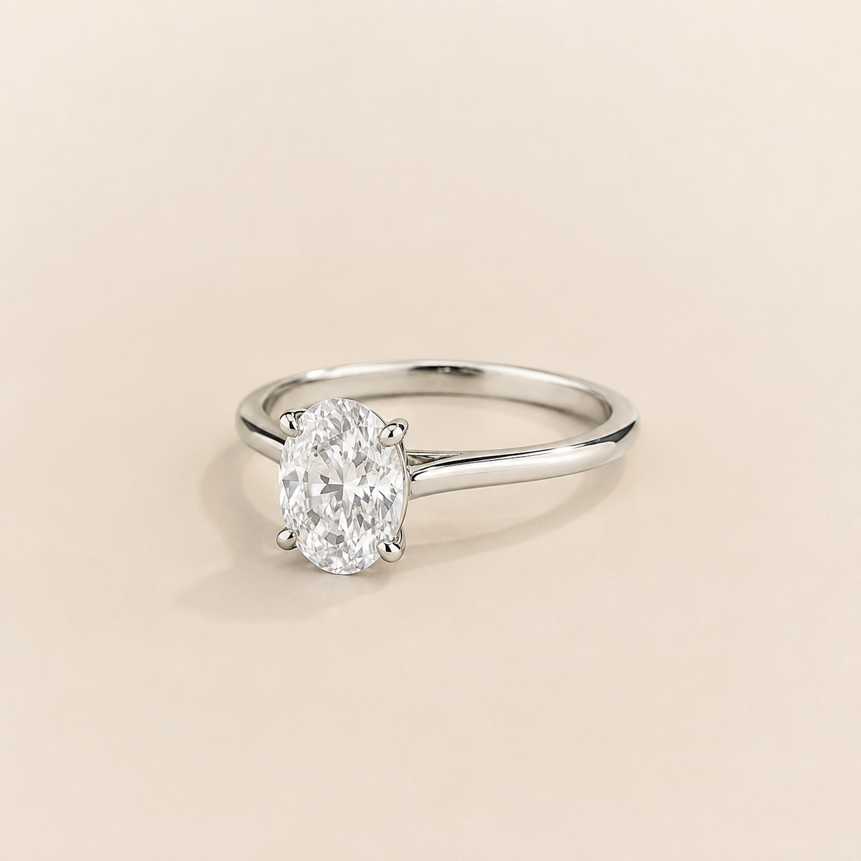 Kissen Ring in white gold, set with a Oval cut Diamond in an east–west setting.