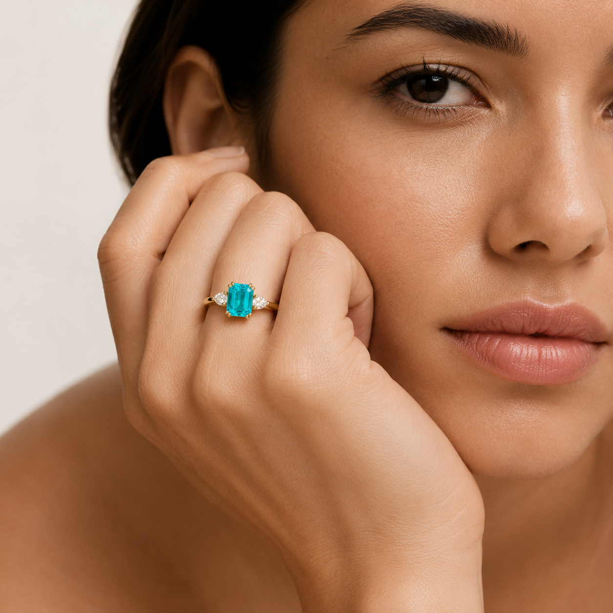 Model wearing the Ailes emerald cut ring, shown in the ruby colourway