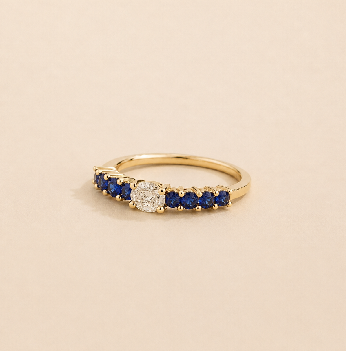 Petra Oval Diamond and Blue Sapphire Half Eternity Ring in Gold Angle view