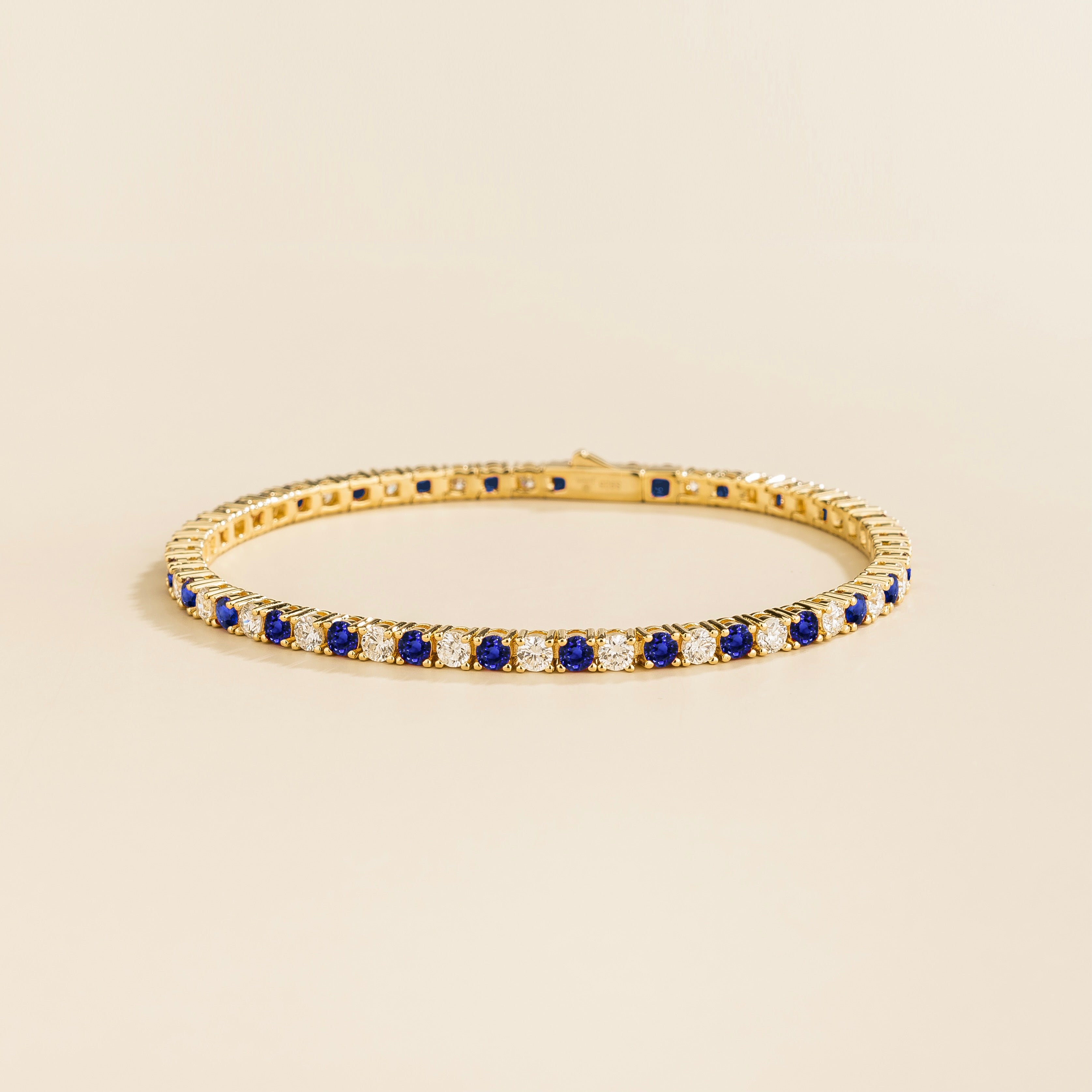 ciclo gold tennis bracelet with round blue sapphire and lab grown diamonds