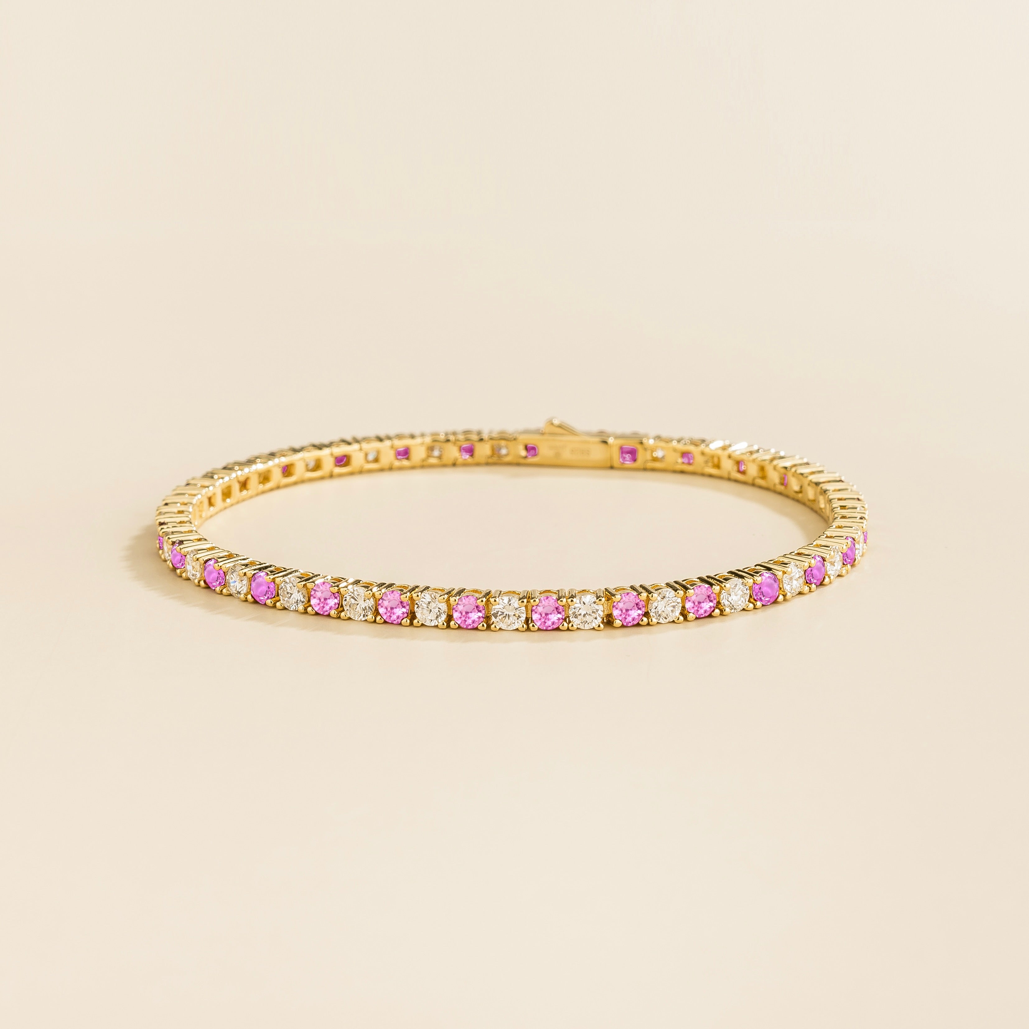 Round lab-grown pink sapphire and diamond tennis bracelet in gold | Juvetti London