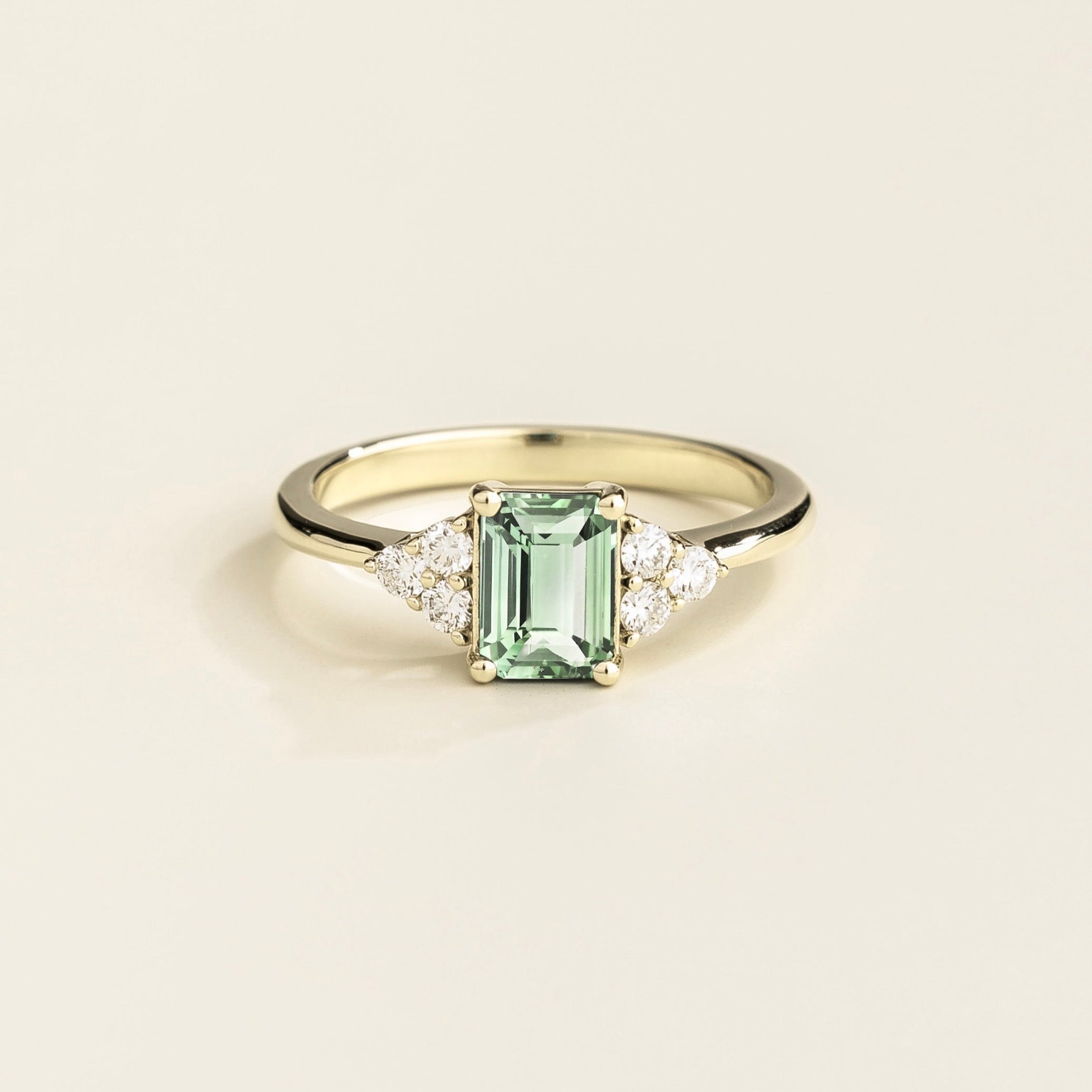 Juvetti white gold ring featuring an emerald-cut lab-grown green sapphire with lab-grown diamond side stones.